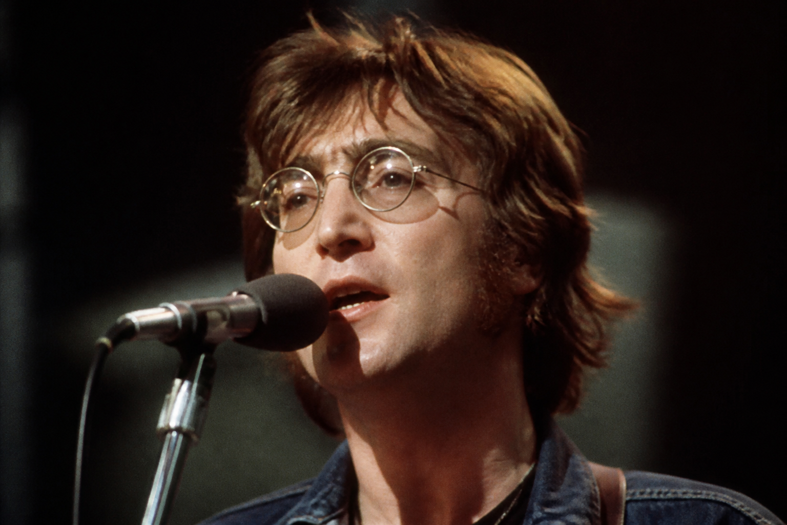 John Lennon performing with intense focus, editorial style