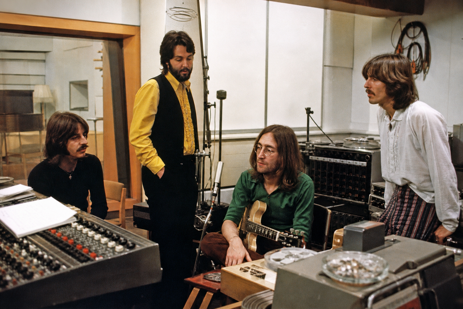 The Beatles at work in a 1967 recording studio with tape machines and microphones