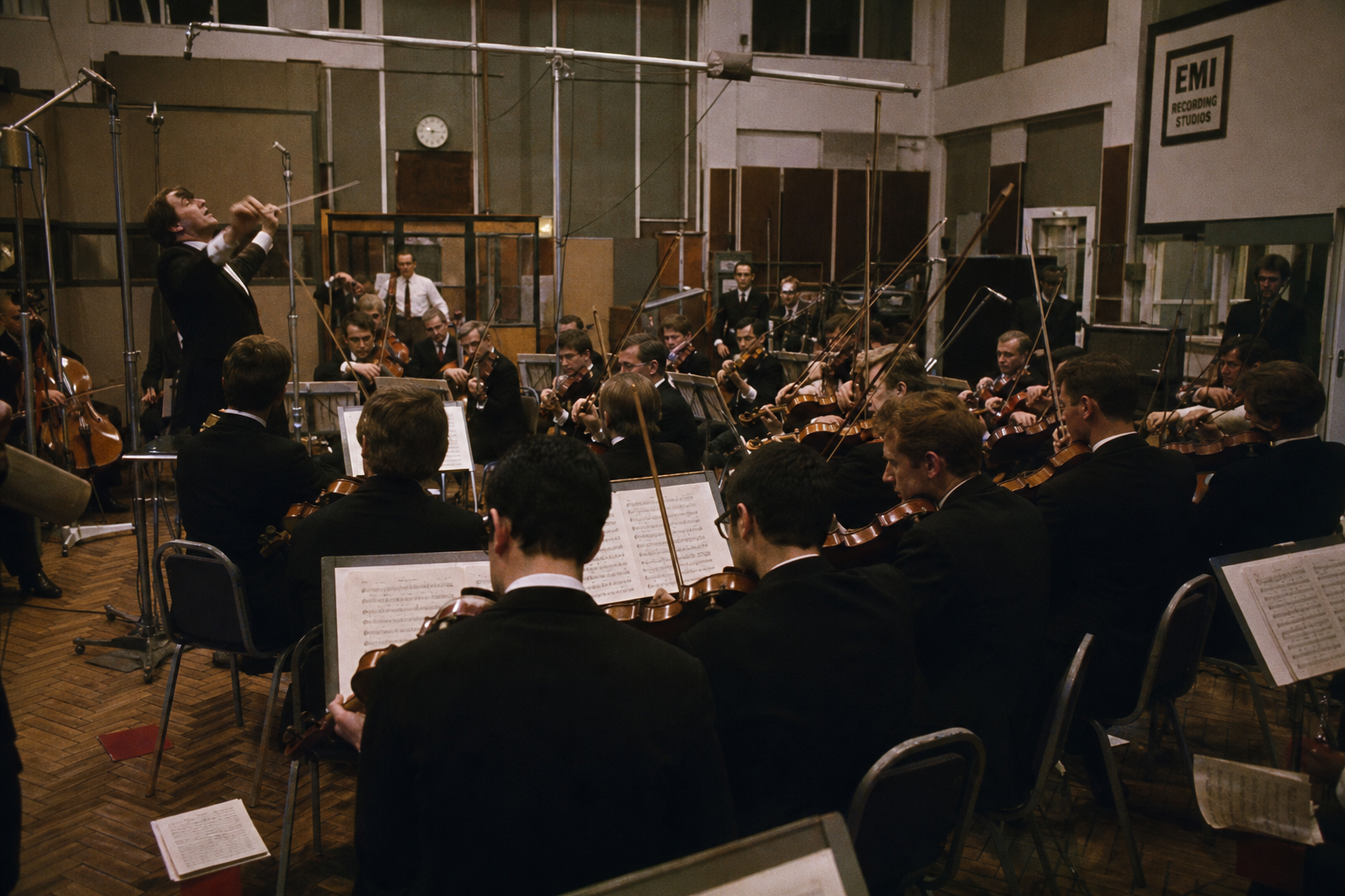 Orchestra musicians performing a rising dissonant crescendo in a Beatles recording session