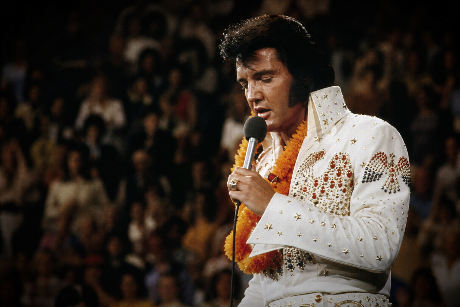 Elvis Presley on stage during a late-career concert performance