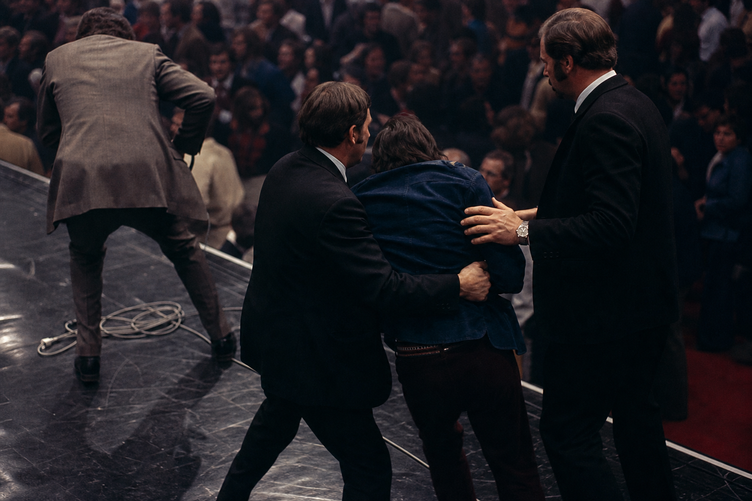 Security staff near a stage edge in a Las Vegas performance venue