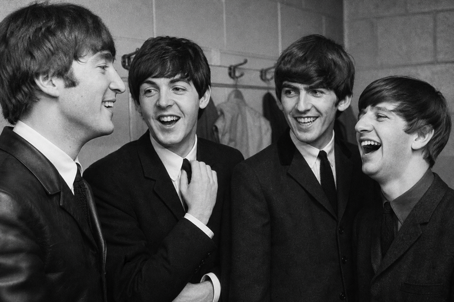 The Beatles laughing backstage in early 1960s Liverpool