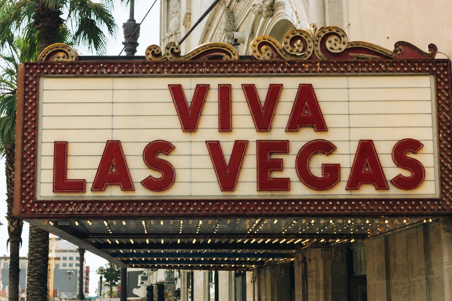 a vintage theater marquee displaying 'Viva Las Vegas' in bold letters